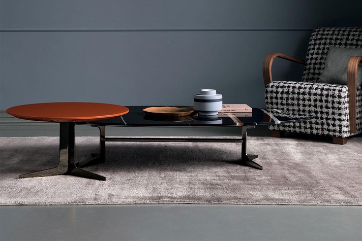 An interesting combo: lower rectangular and taller round coffee tables in marble and lacquer