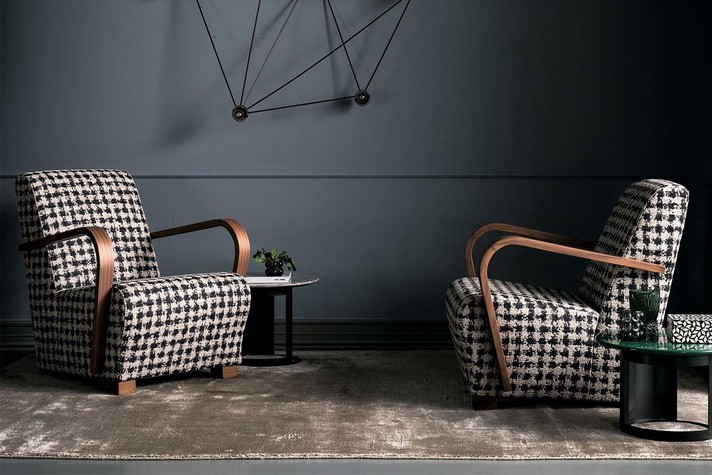 A stylish conversation area with houndstooth upholstered armchairs