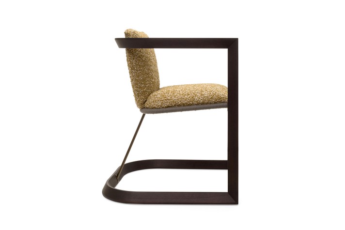Lateral view of the designer armchair, showing the solid ash wood and steel frame