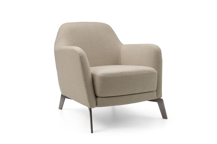 Lounge armchair with high metal feet and a generous seat cushion