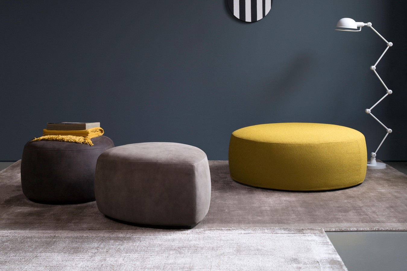 Contemporary, minimalist upholstered pouffes with a low wooden plinth base