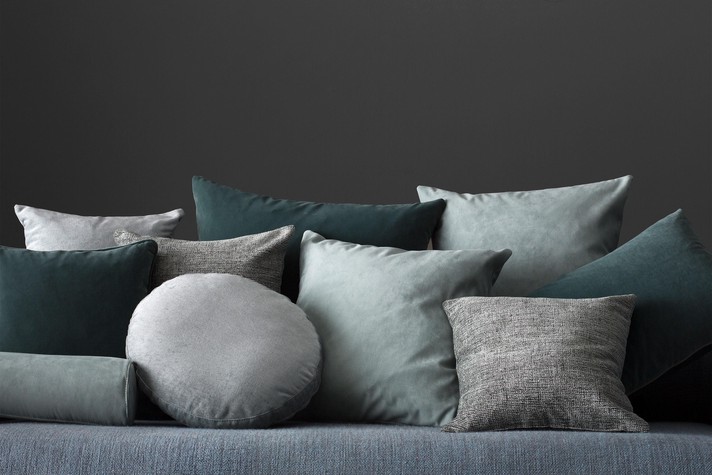 Combine cushions of different sizes and materials to decorate a contemporary sofa