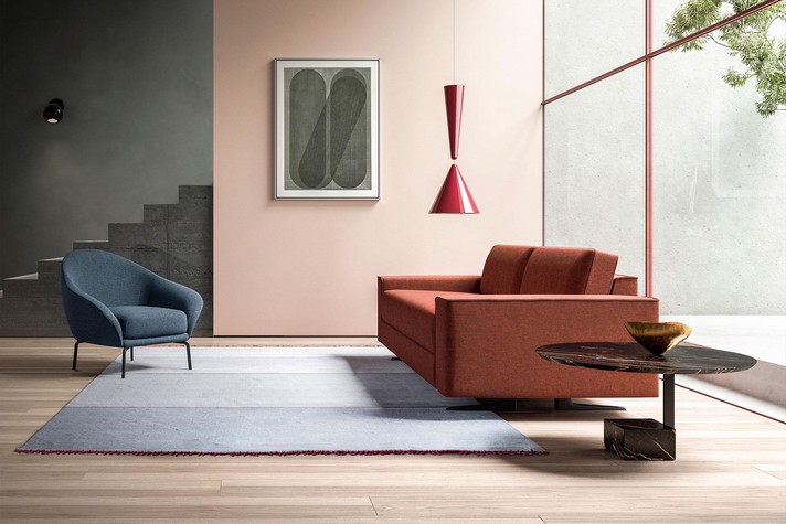 Highly modern design with wide armrests and single-piece seat