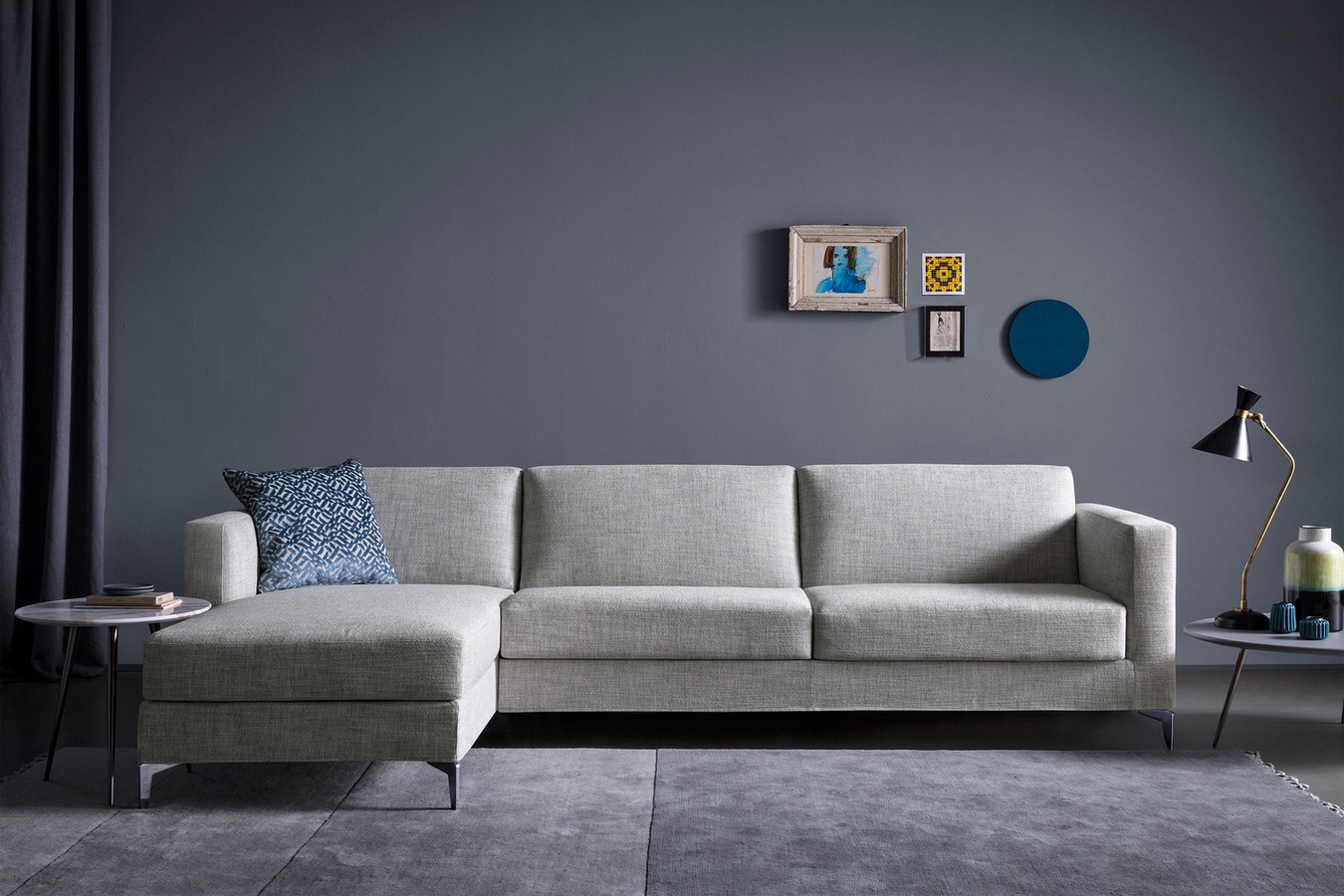 High sectional sofa bed with tapered metal legs and track arms