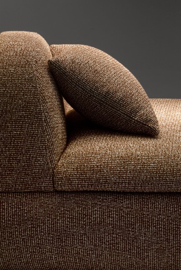 Goose-down cushion resting on the backrest of the chaise longue
