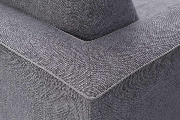 Detail of arm and backrest joined and embellished with a contrasting piping