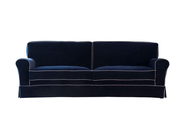 Blue velvet sofa with white piping, a great choice for coastal style interiors