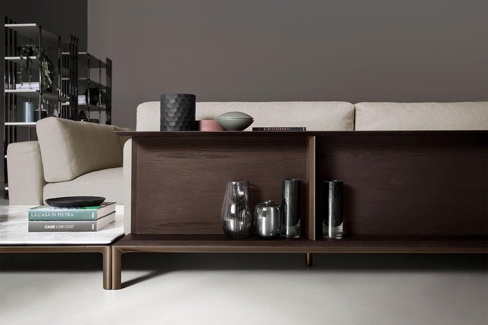 The aluminium base integrates the bookcase and marble top