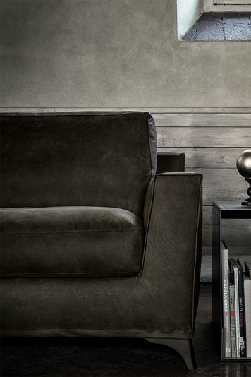 Detail of the vintage leather and solid wood arched leg
