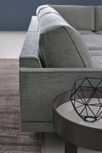 Detail of the slightly inclined backrest and the generous feather cushions