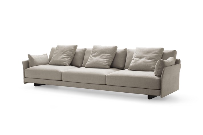 Front view of the sofa with fabric armrests and feather cushions