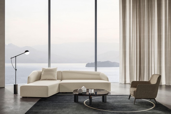 Asymmetrical sofa covered in fabric
