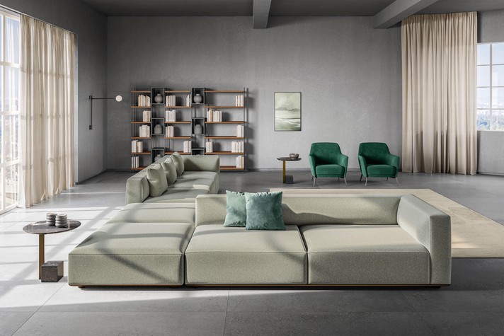 Relaxation island formed by a large modular corner sofa with double-sided seats