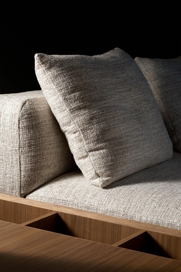 Details of the seat with the low backrest and wooden side table