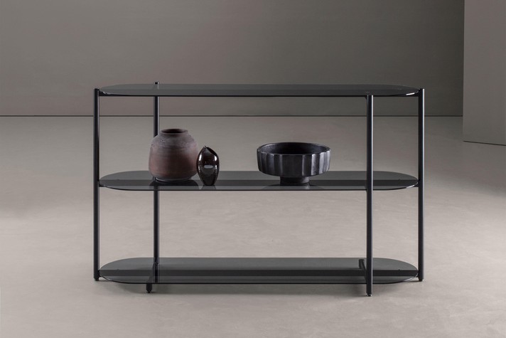 The use of clear glass visually lightens the bookcase, lending the piece a sense of visual and structural lightness