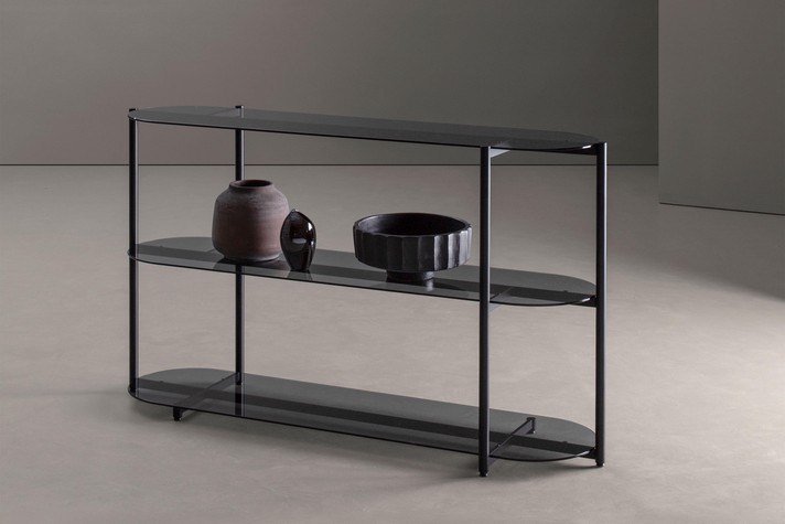 The Alma bookcase in a console configuration, shown here with clear smoked glass shelves