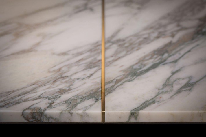Details of the contrasting inlays of the marble top of the Pilar table