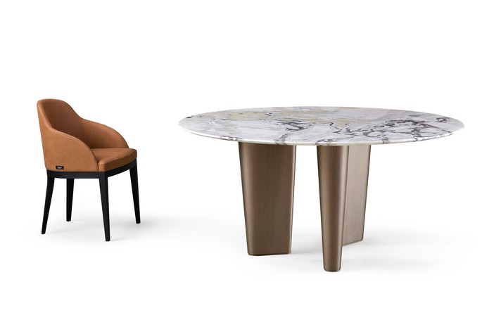 The round tabletop is available in a choice of prized marble options