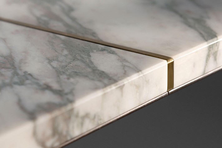 Details of the contrasting inlays of the marble top of the Pilar table
