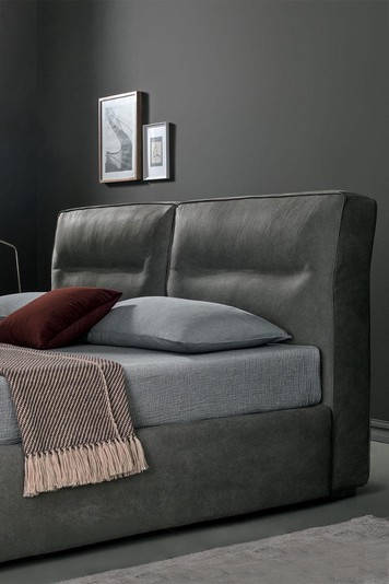 Detail of the cushioned headboard with decorative horizontal stitching
