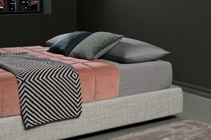 The upholstered bed frame takes up only a few centimetres more than the mattress