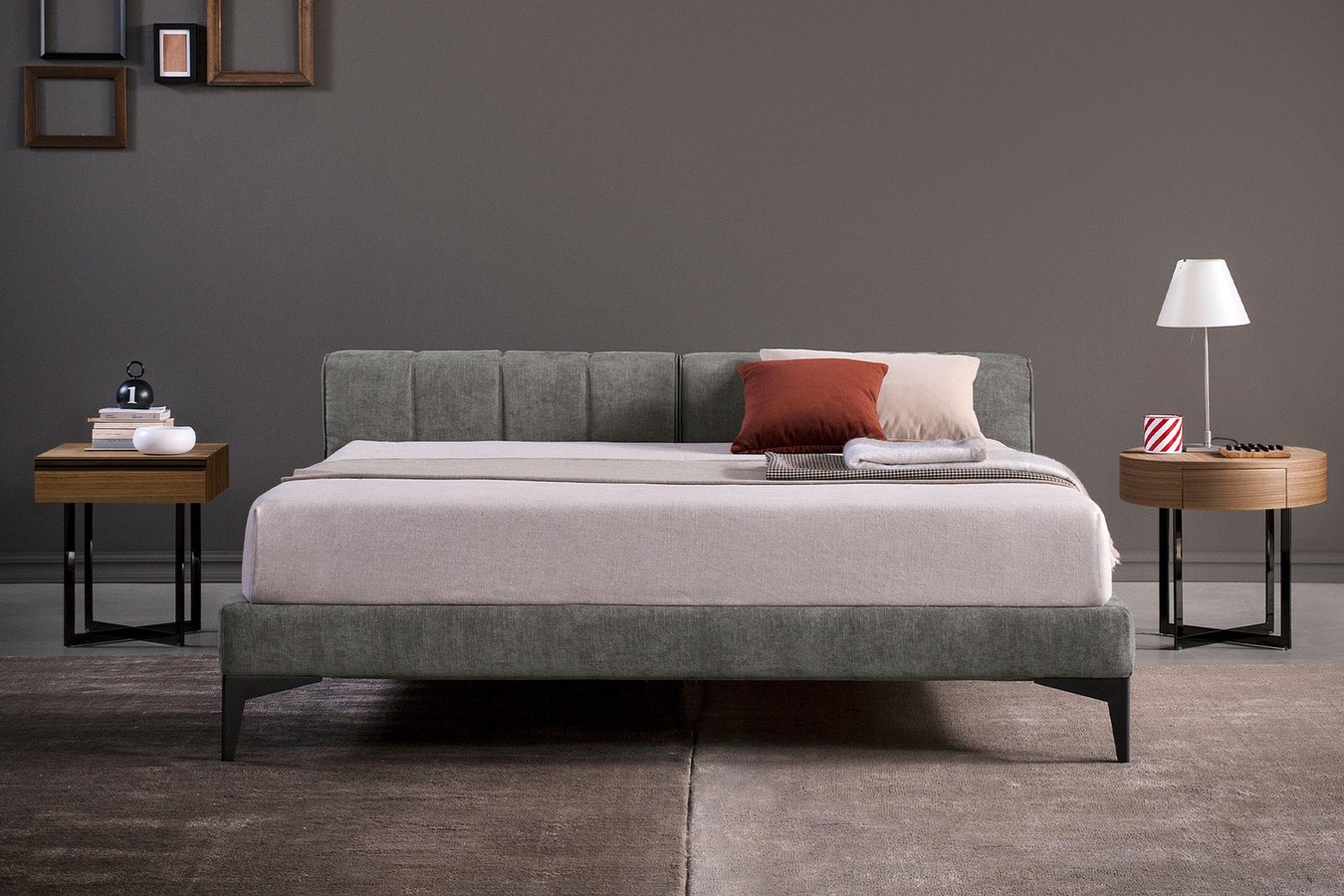 Upholstered king size low headboard bed with high tapered metal legs