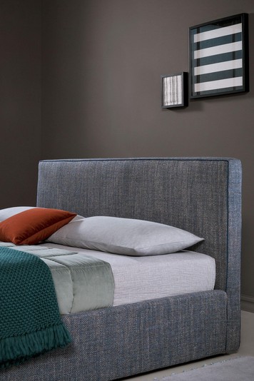 High, square headboard with contrast piping