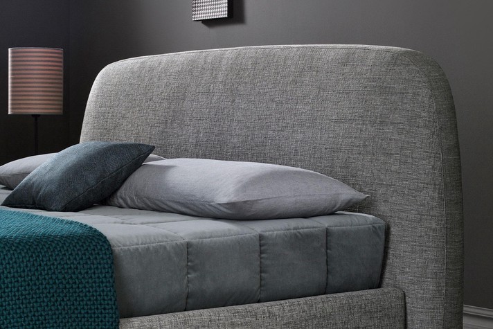 Bed with plain curved headboard