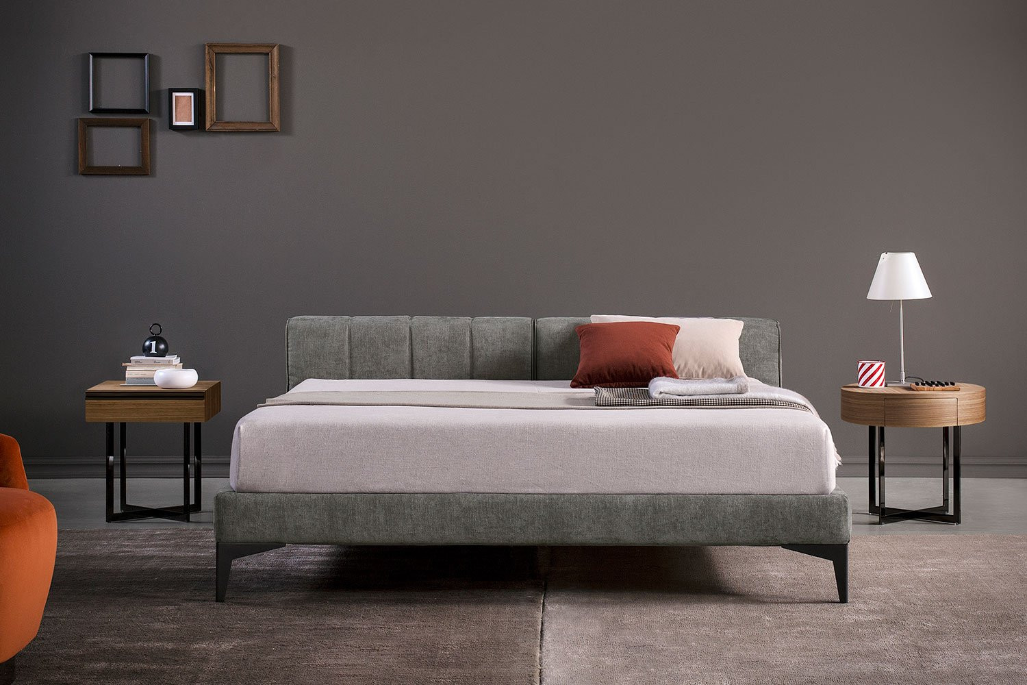 Upholstered king size low headboard bed with high tapered metal legs