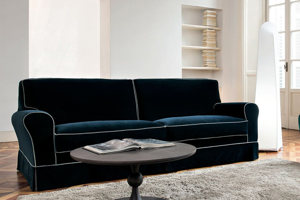 Classic 2, 3 or 4-seater rolled arm skirted sofa enriched with contrasting edge piping