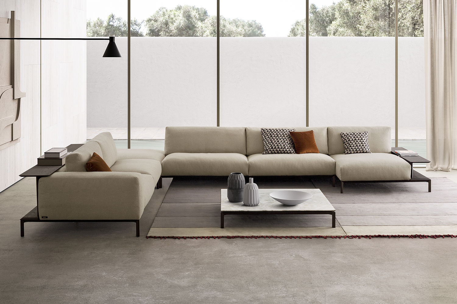 Contemporary high legged modular sofa with wrap around bookcase and aluminium raised deck