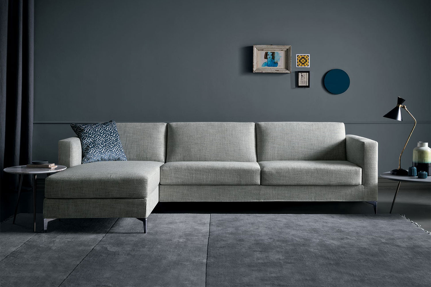 High sectional sofa bed with tapered metal legs and track arms
